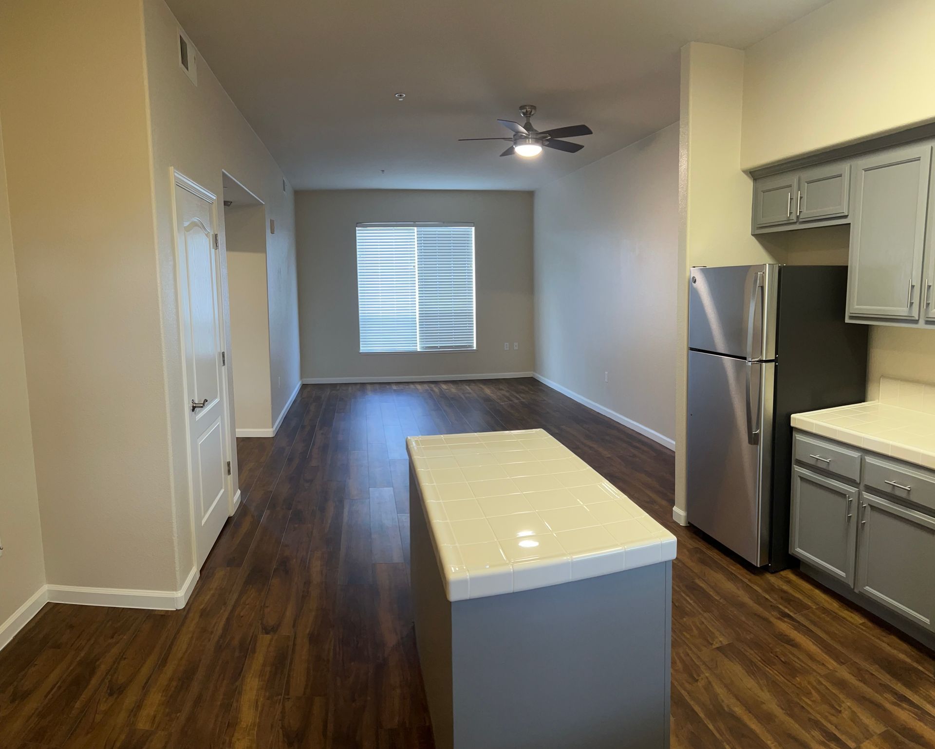 A kitchen with stainless steel appliances and a large island in the middle of the room.