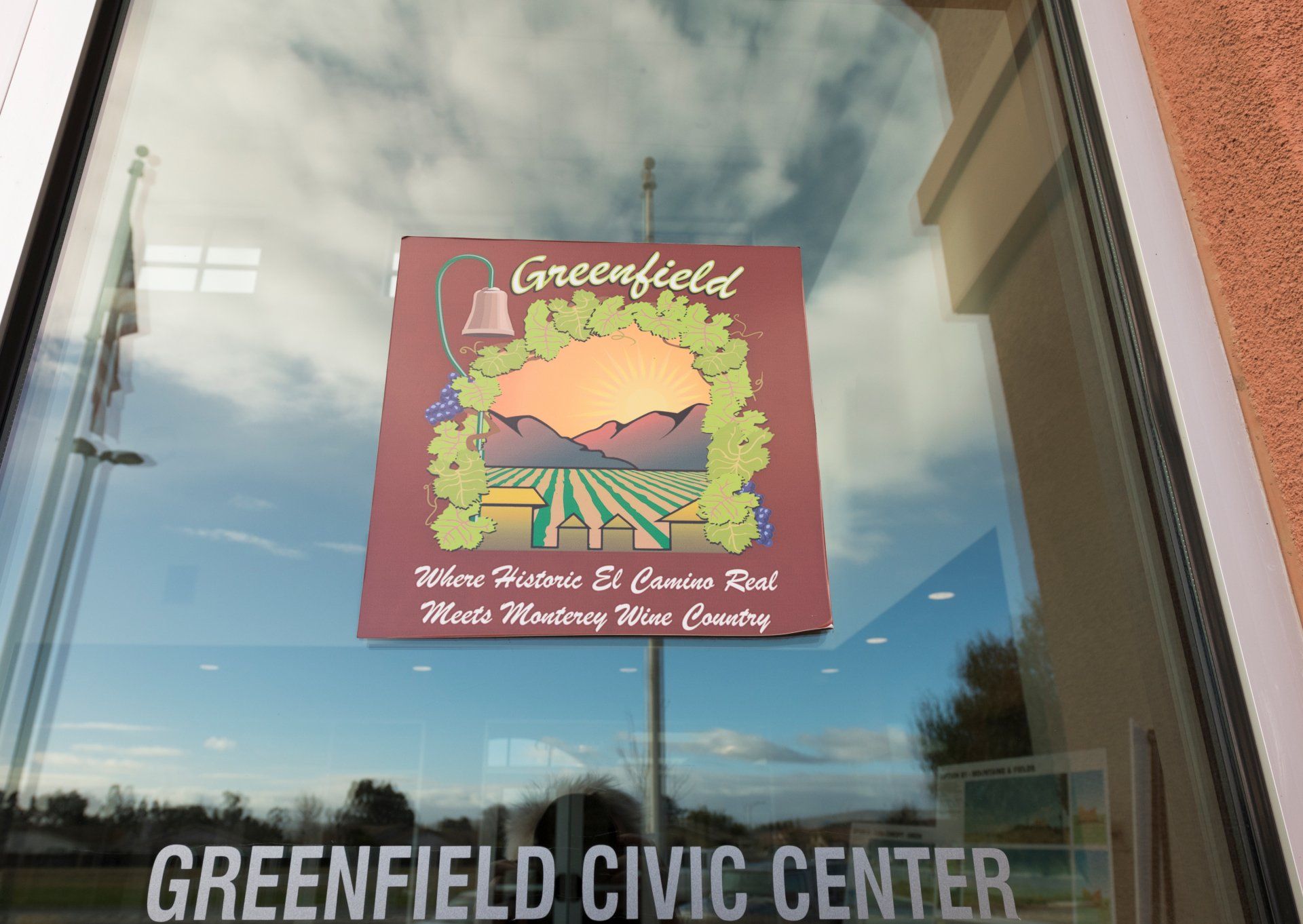 A greenfield civic center sign is on a window