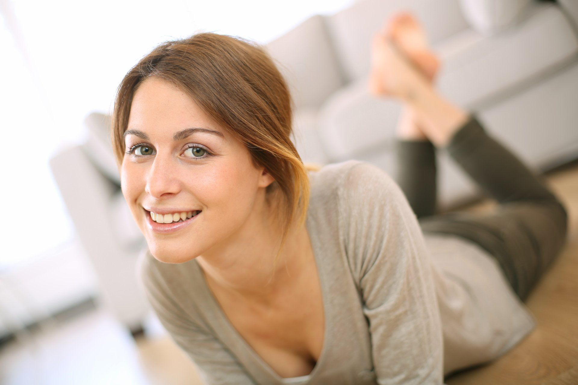 A woman smiling in the living room.