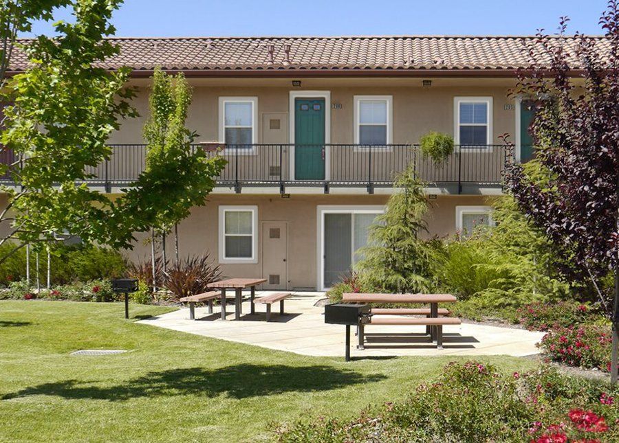 A building with a picnic area in front of it