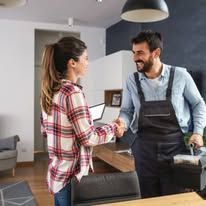 Customer and barista smiling and shaking hands at a café counter