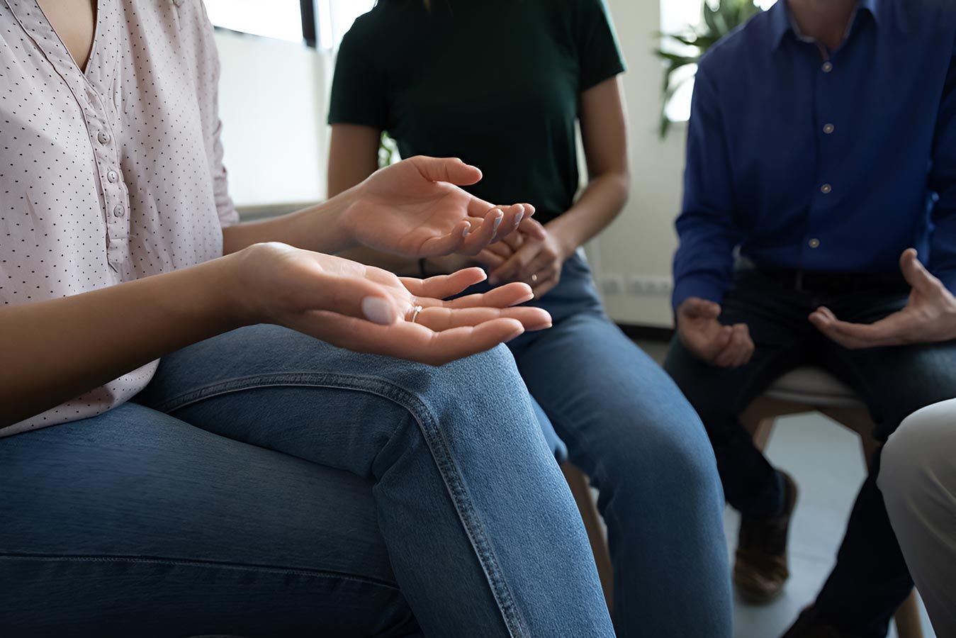A Group of People Are Sitting in a Circle Talking to Each Other — Living Well Psychology Clinic in Erina, NSW