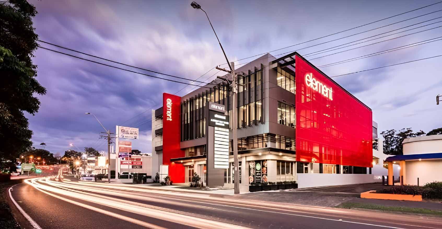A Large Red Building is Sitting on the Side of a Road — Living Well Psychology Clinic in Erina, NSW