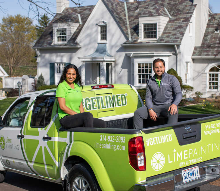 lime paining pickup truck with two people in the back