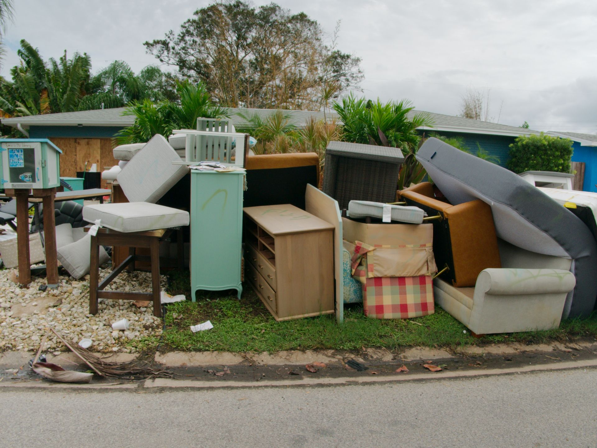 A pile of furniture is sitting on the side of the road