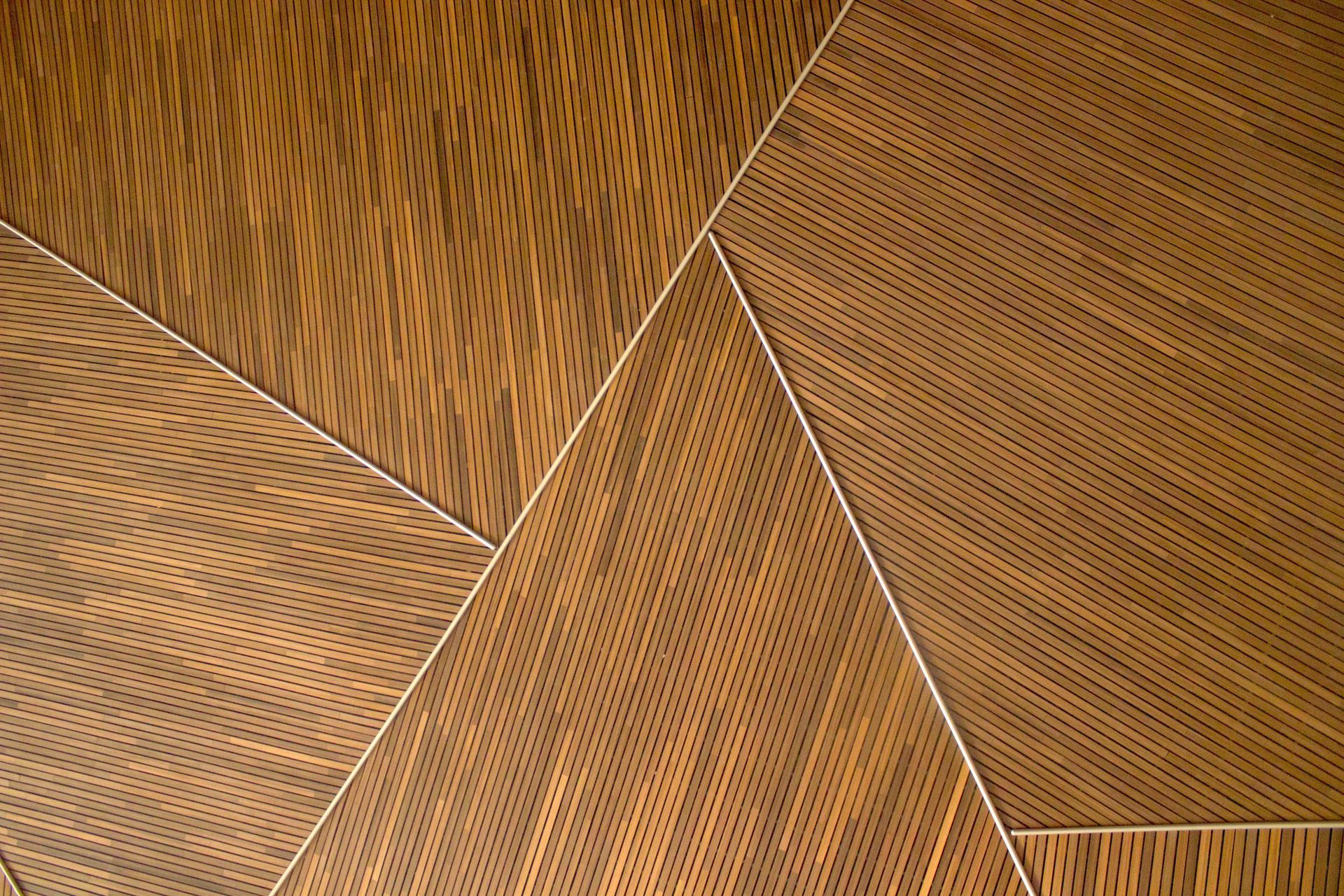 A close up of a wooden floor with a geometric pattern.