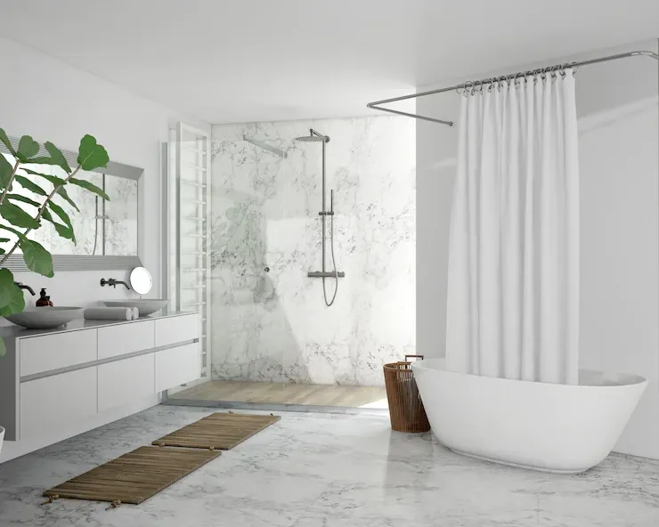Modern bathroom with white walls, shower, freestanding tub, and a leafy plant.