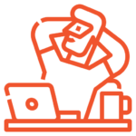 Man leaning back at desk with laptop and coffee mug.