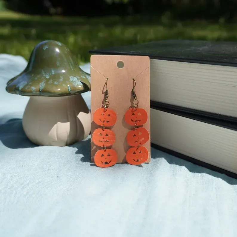A pair of orange pumpkins stacked earrings