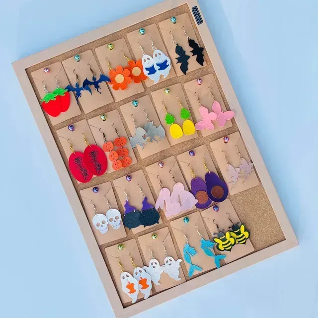 A wooden display case filled with a variety of earrings