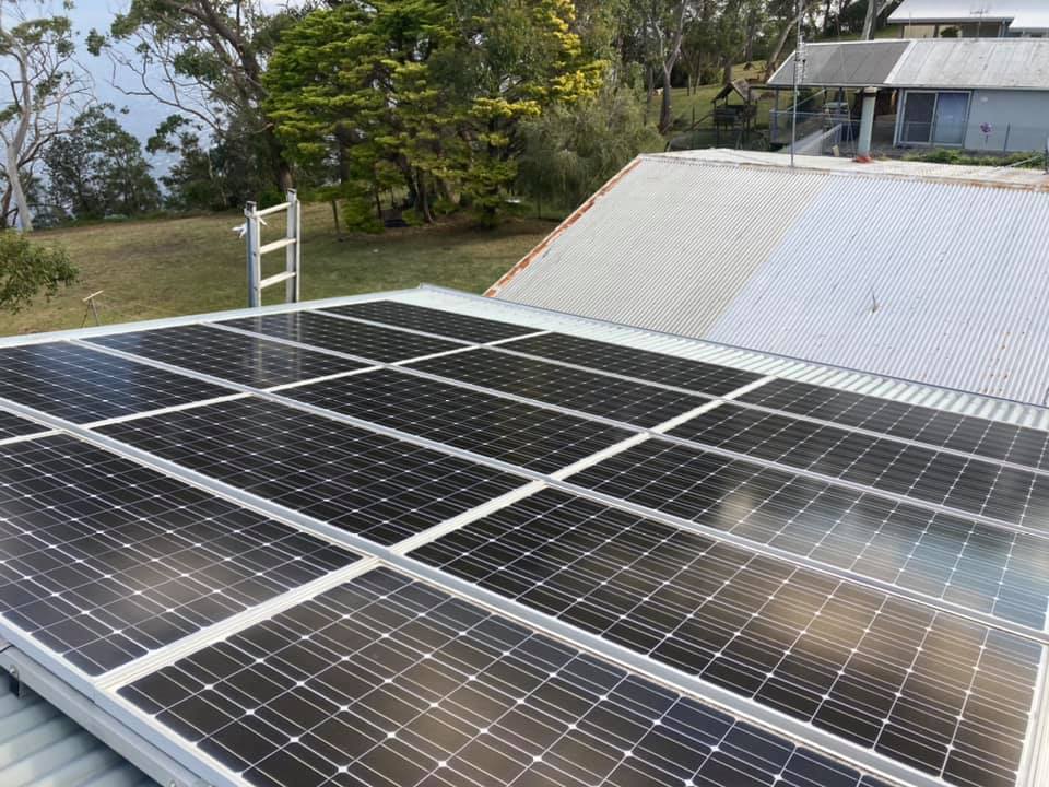 Solar Panels On A Grey Tin Roof — Gutter Cleaning In Shoalhaven, NSW