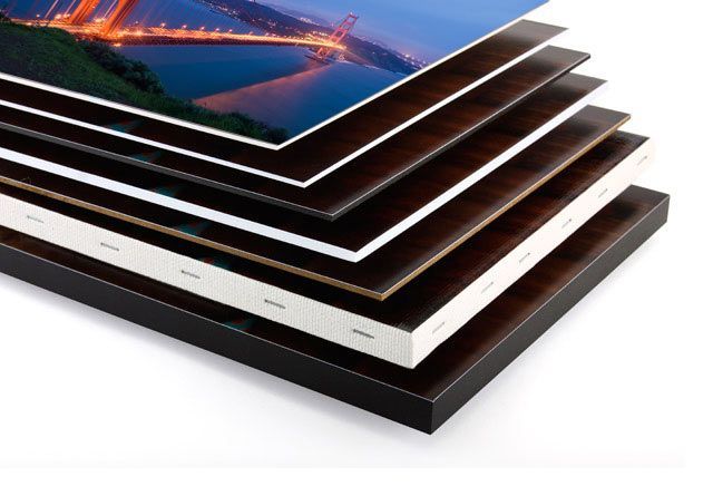 a stack of canvases sitting on top of each other on a white surface .
