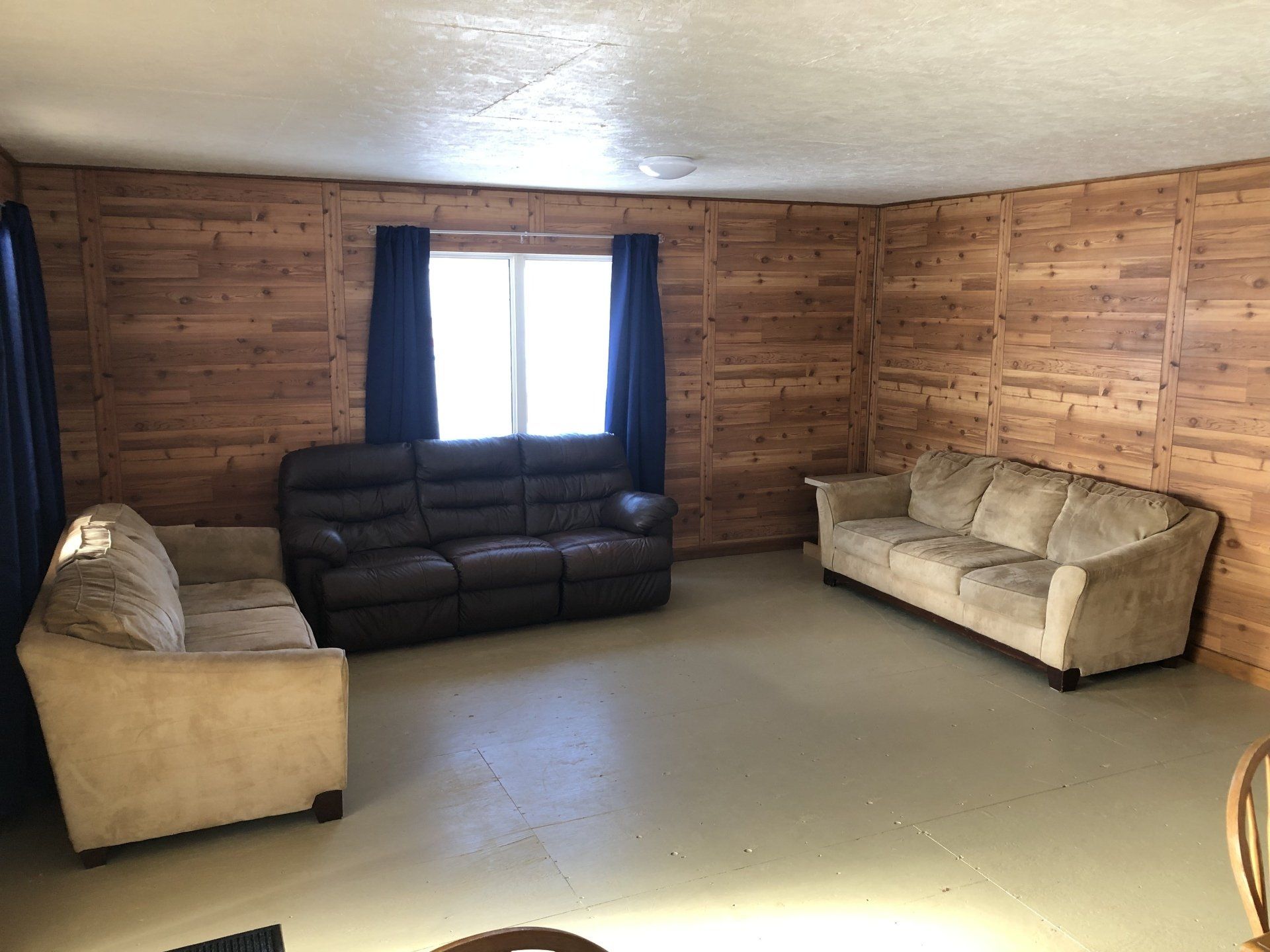 A living room with two couches and a window.