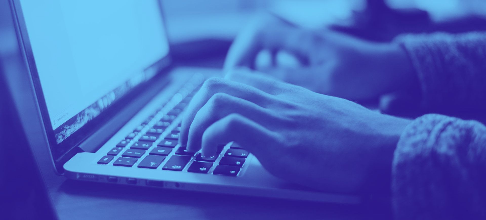 A person is typing on a laptop computer.