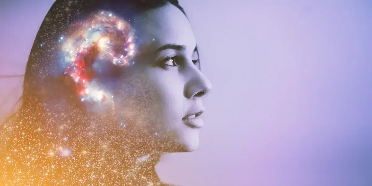 Woman with the galaxy overlaid on her head; purple and gold hues.