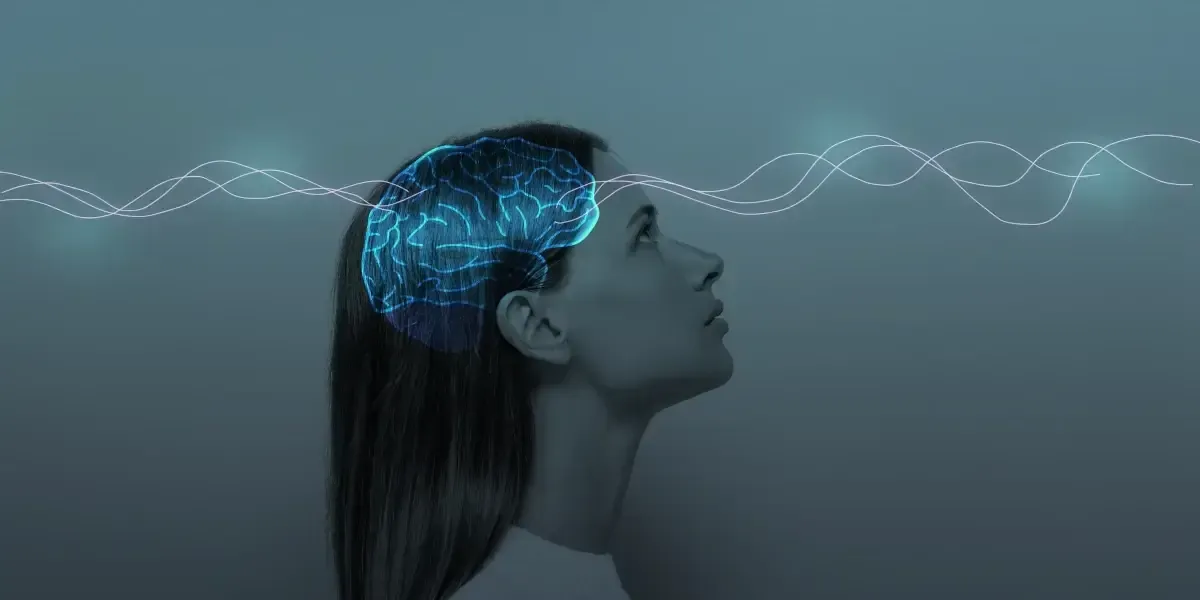 Woman looking up, with a glowing brain overlay and wavy lines emanating from her head.