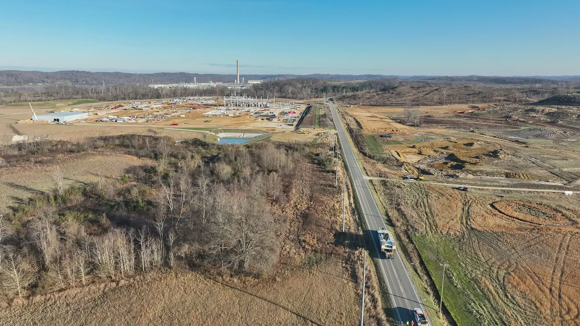 An aerial view of a truck driving down a highway.