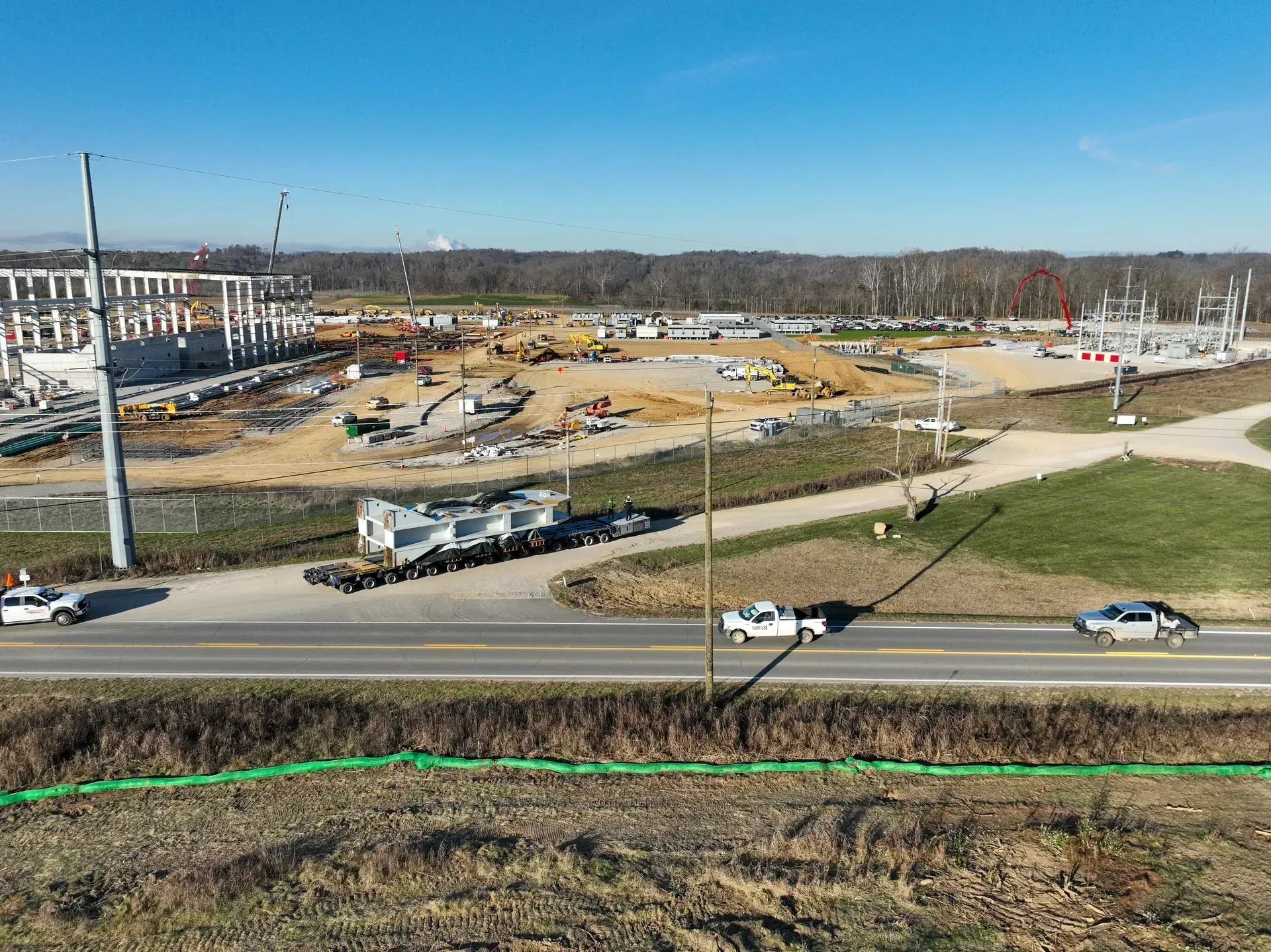 An aerial view of a construction site next to a highway.