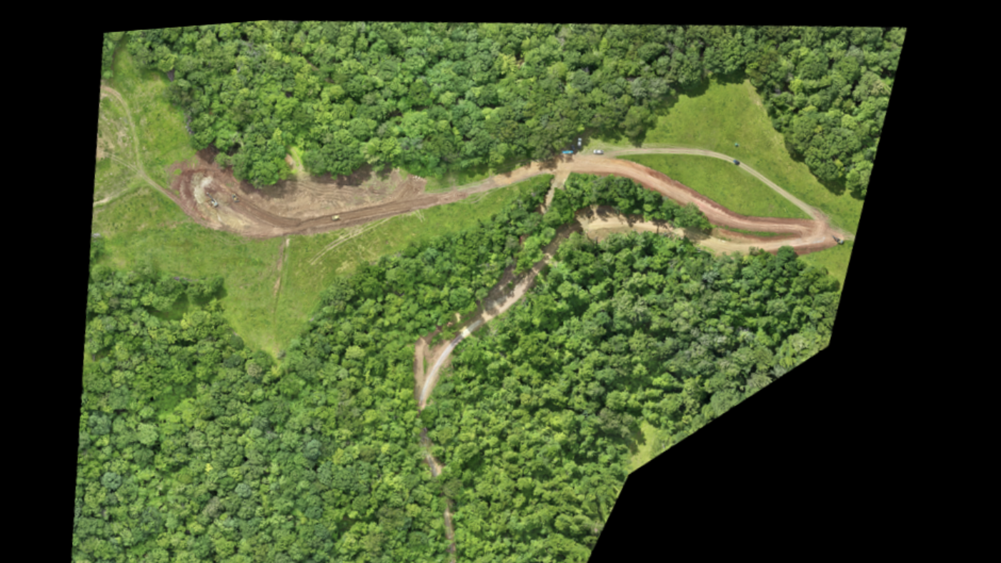 An aerial view of a cell phone tower in the middle of a field.