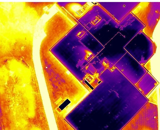 An aerial view of a purple and yellow building