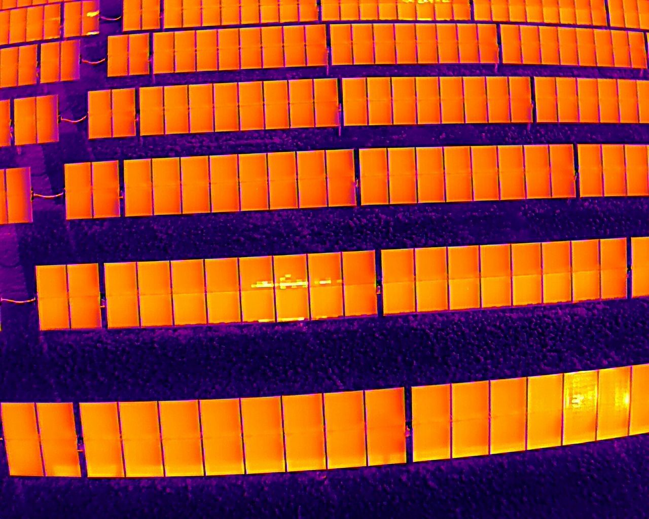 An aerial view of a building with a lot of orange windows.