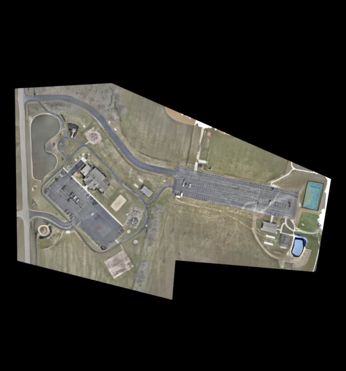An aerial view of a residential area with a large building in the middle