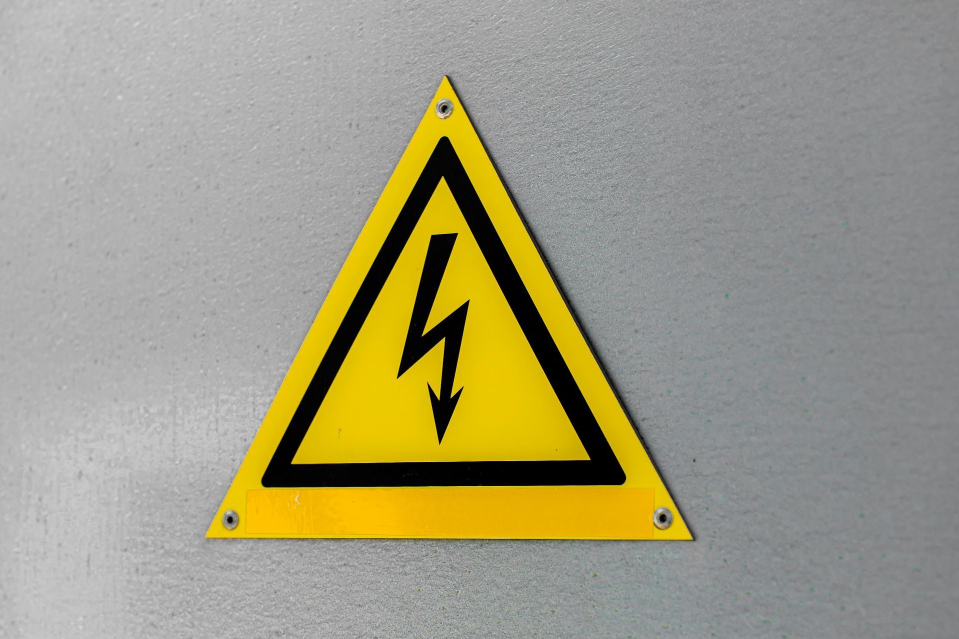 Yellow triangle with black lightning bolt, warning of electrical hazard.