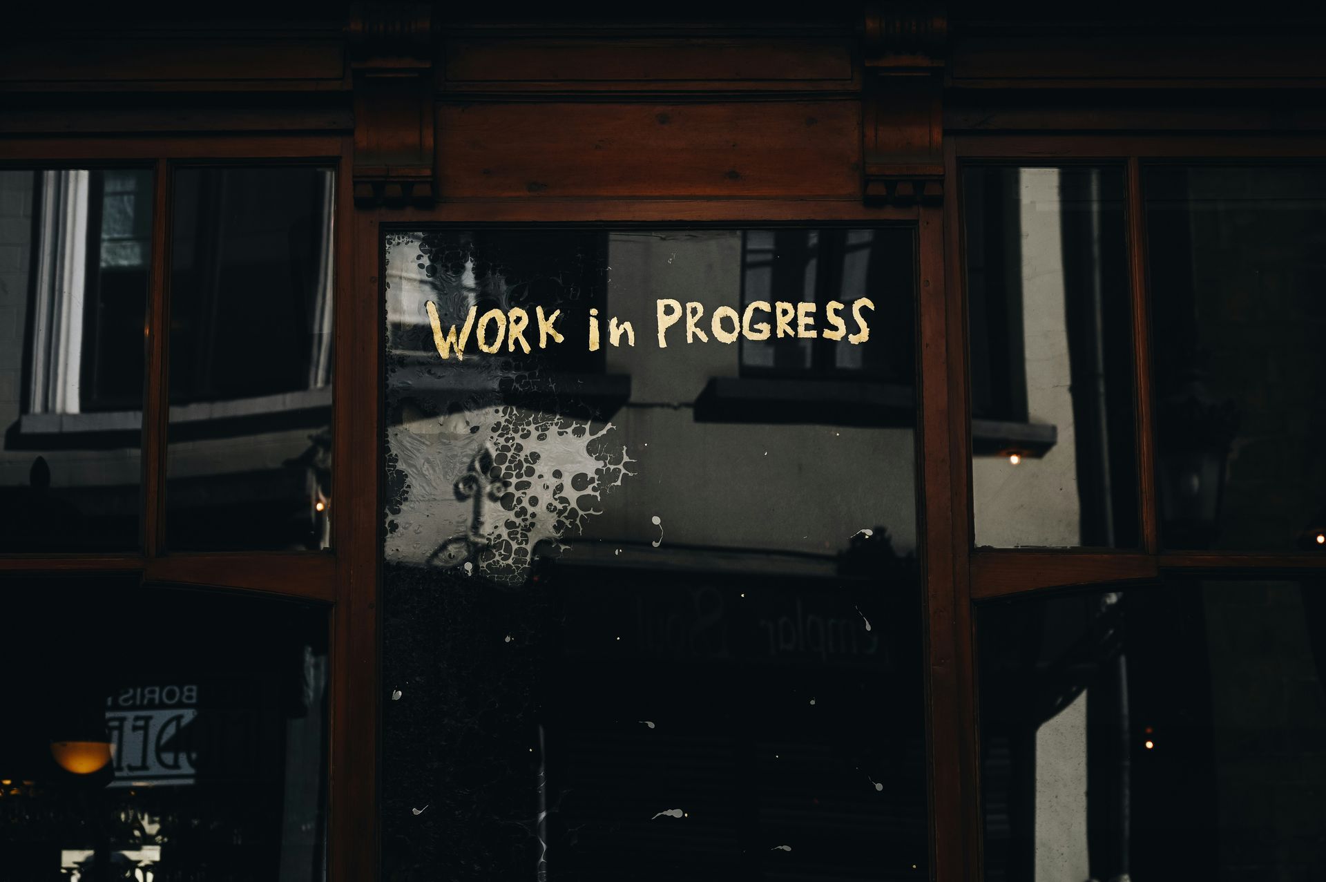 Dark shop window reads