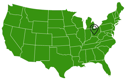 A green map of the united states with a pin pointing to a city.