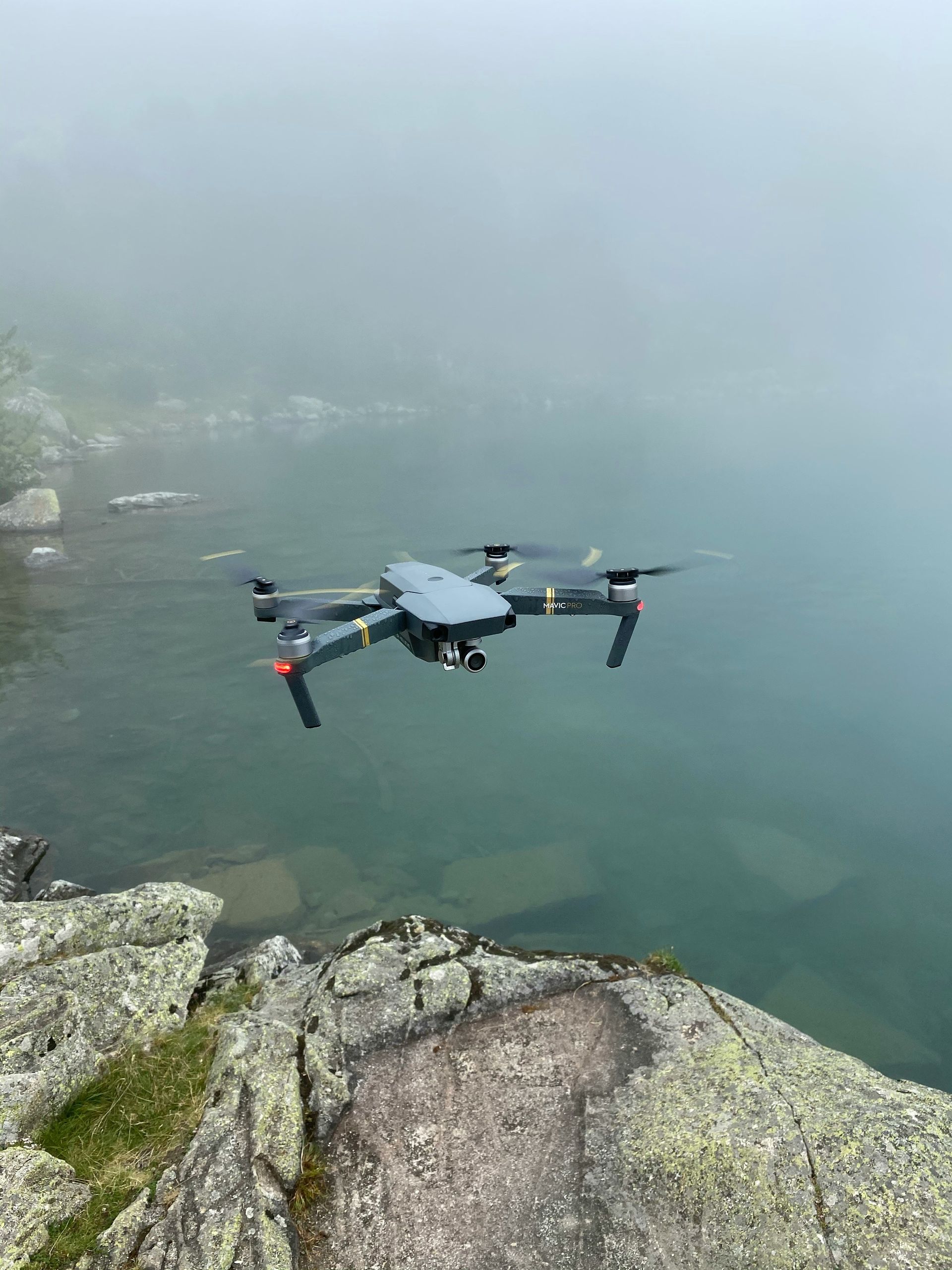 A drone is flying over a body of water.