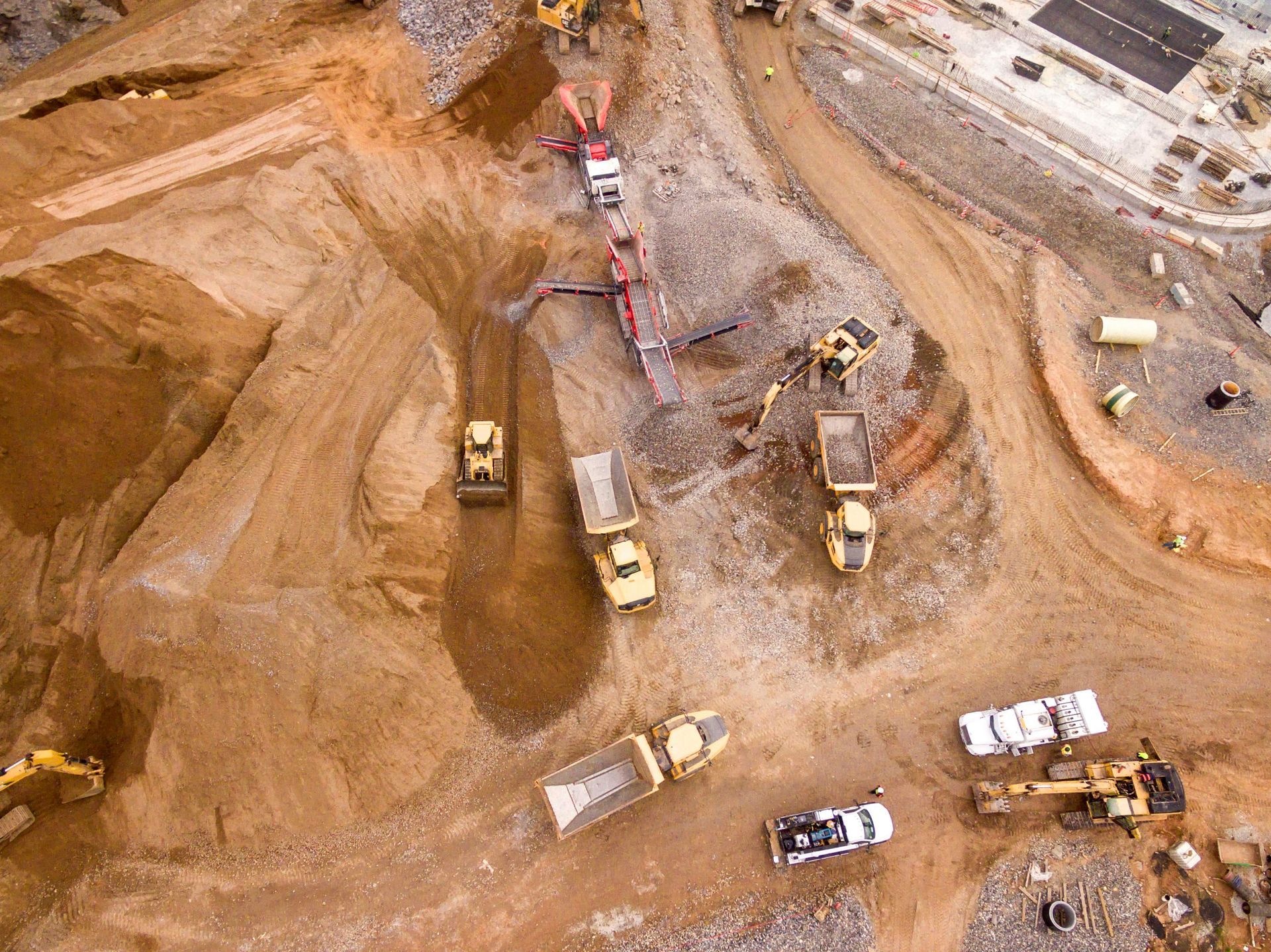 An aerial view of a construction site with a lot of machinery.