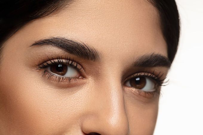 A close up of a woman 's face with her eyes closed