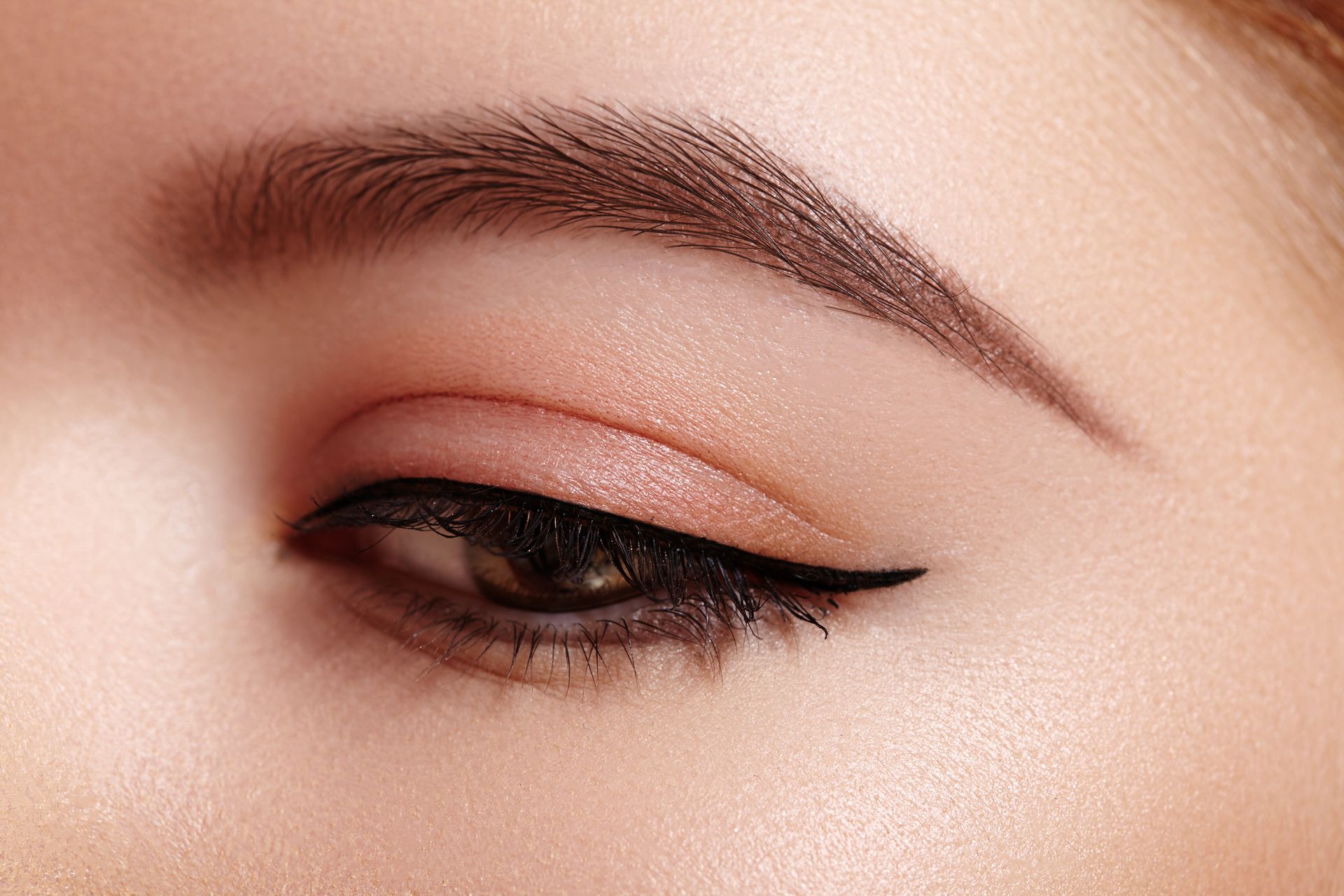 A close up of a woman 's eye with eyeliner.