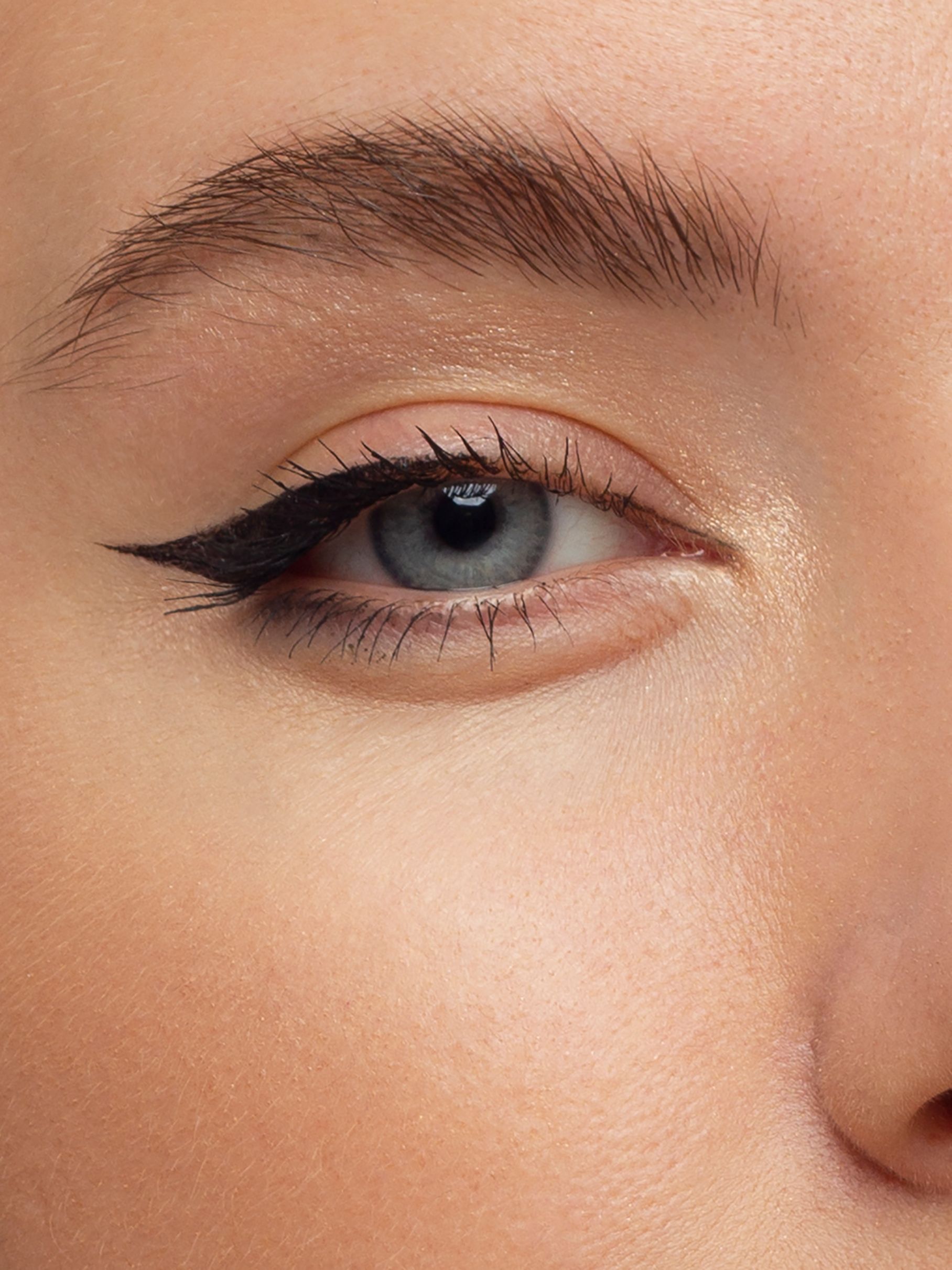 A close up of a woman 's eye with eyeliner.