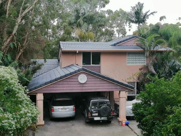 A House With Two Cars Parked in the Garage — Roofing Gold Coast in Tallebudgera, QLD