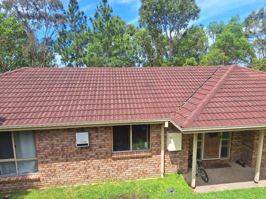 A Brick House With a Red Tiled Roof and a Porch — Roofing Gold Coast in Tallebudgera, QLD