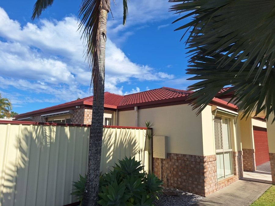 A House With a Palm Tree in Front of It — Roofing Gold Coast in Tallebudgera, QLD