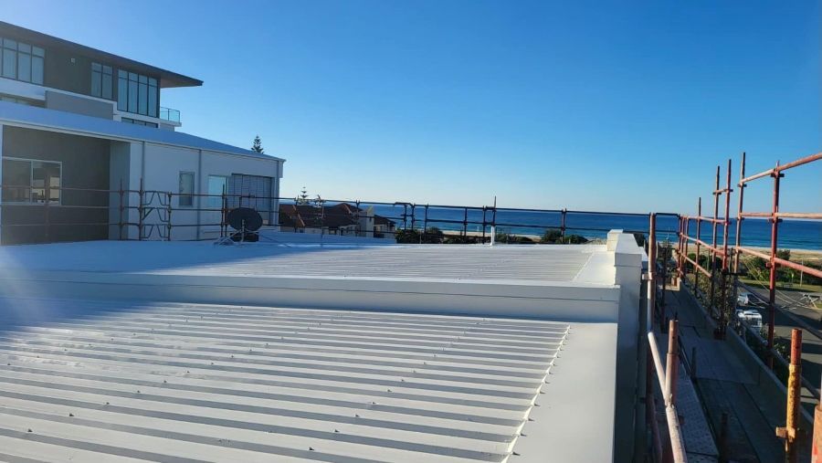 A Building Under Construction With a View of the Ocean — Roofing Gold Coast in Tallebudgera, QLD
