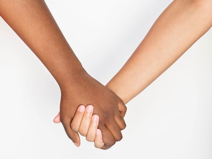 closeup of two people holding hands