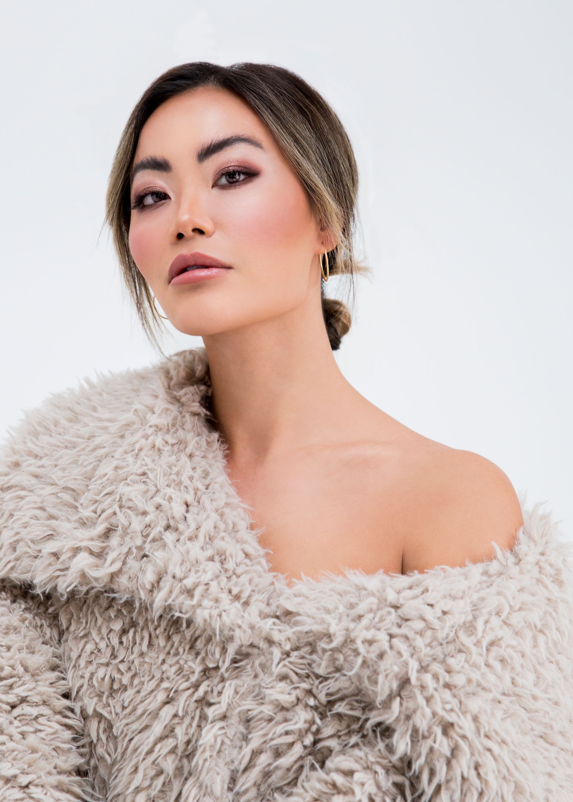 headshot of beautiful asian woman with makeup and fur coat
