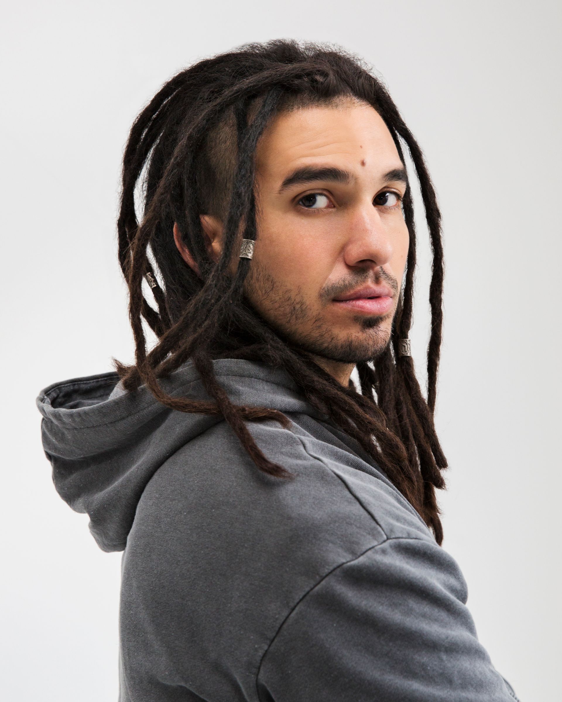 young male with dreadlocks staring at camera