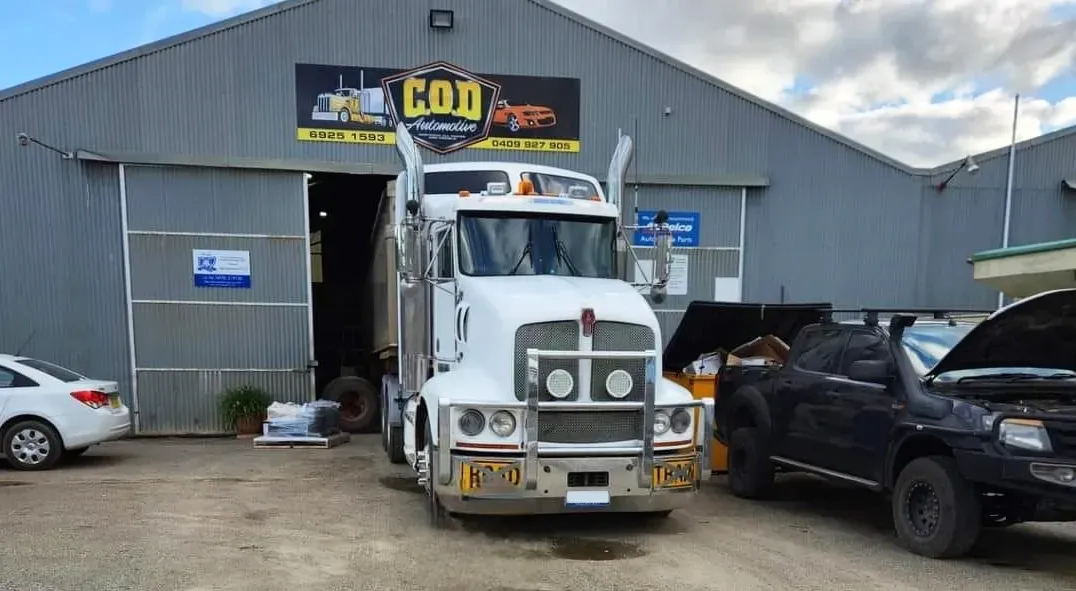 A White Semi-truck is Parked in Front of a Repair Shop — COD Automotive in  Ashmont, NSW