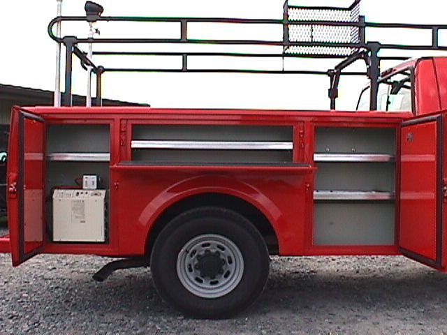 A red truck with the doors open and a ladder on top A red truck with the doors open and a ladder on top