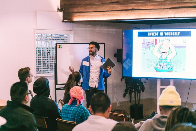 A man is giving a presentation to a group of people in a room.