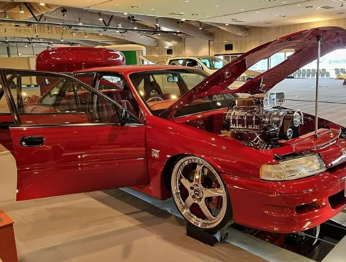A Red Car With the Hood Open is Parked in a Garage — South Coast Radiators In Southern Highlands, NSW