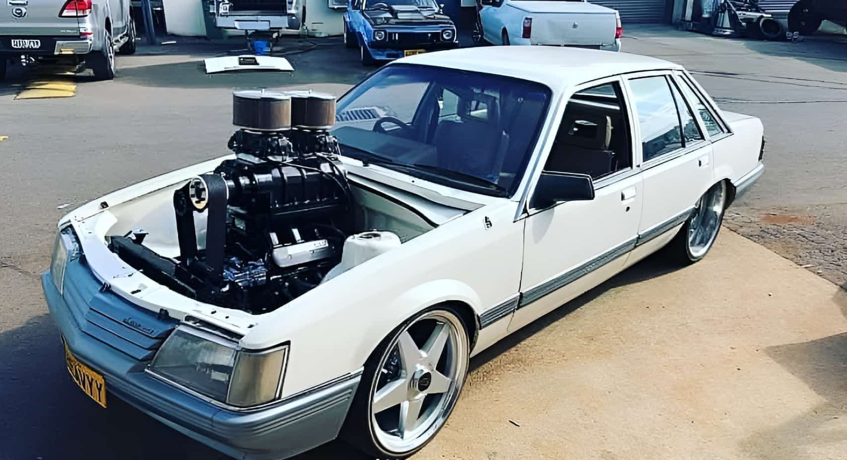 A White Car With the Hood Up is Parked — South Coast Radiators In Penrith, NSW