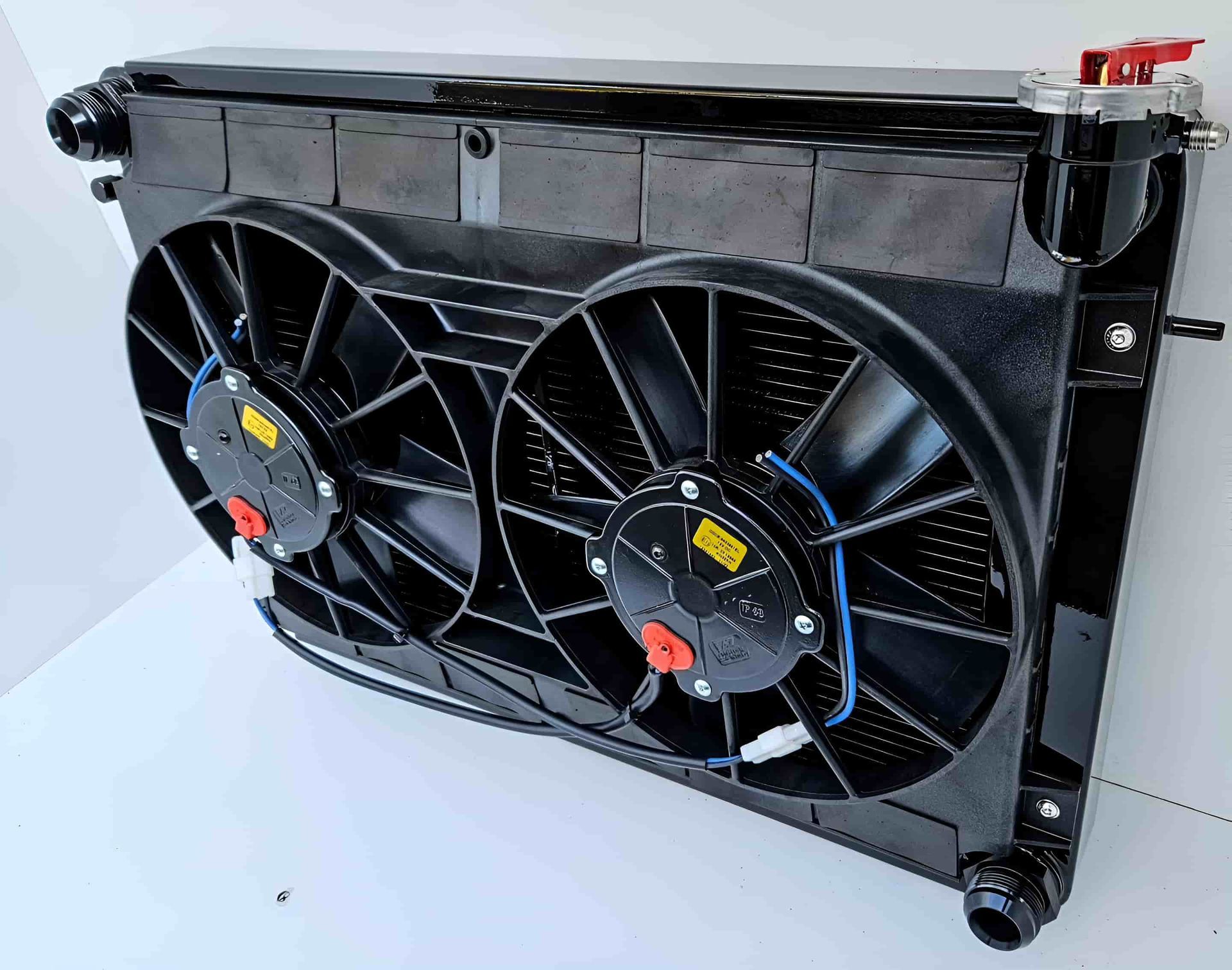 A Radiator With Two Fans Attached to It is Sitting on a White Surface — South Coast Radiators In Liverpool, NSW