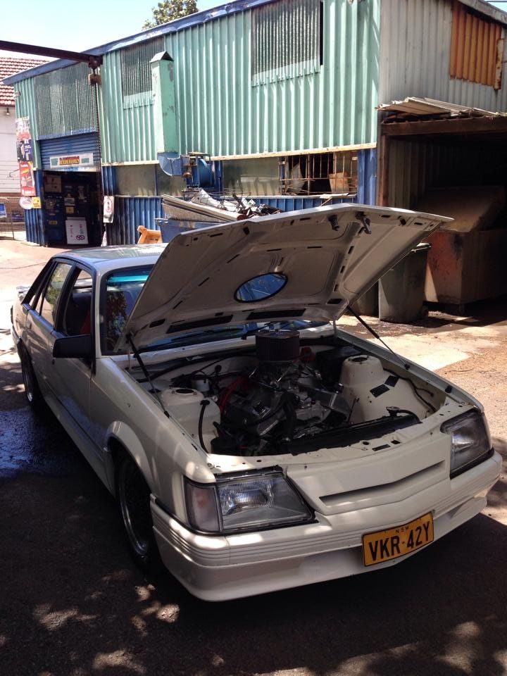 A White Car With the Hood Up Has a Having a Repair — South Coast Radiators In Woonona, NSW