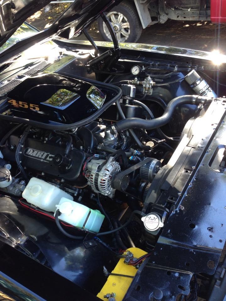 The Engine of a Black Car With the Hood Open — South Coast Radiators In Woonona, NSW