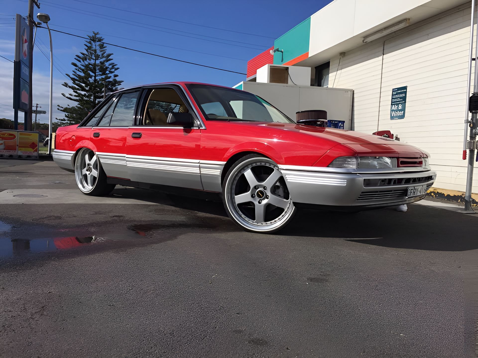 A Red and Silver Car is Parked in Front of a Building — South Coast Radiators In Nowra, NSW
